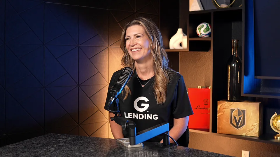 G. Lending team member at the microphone
