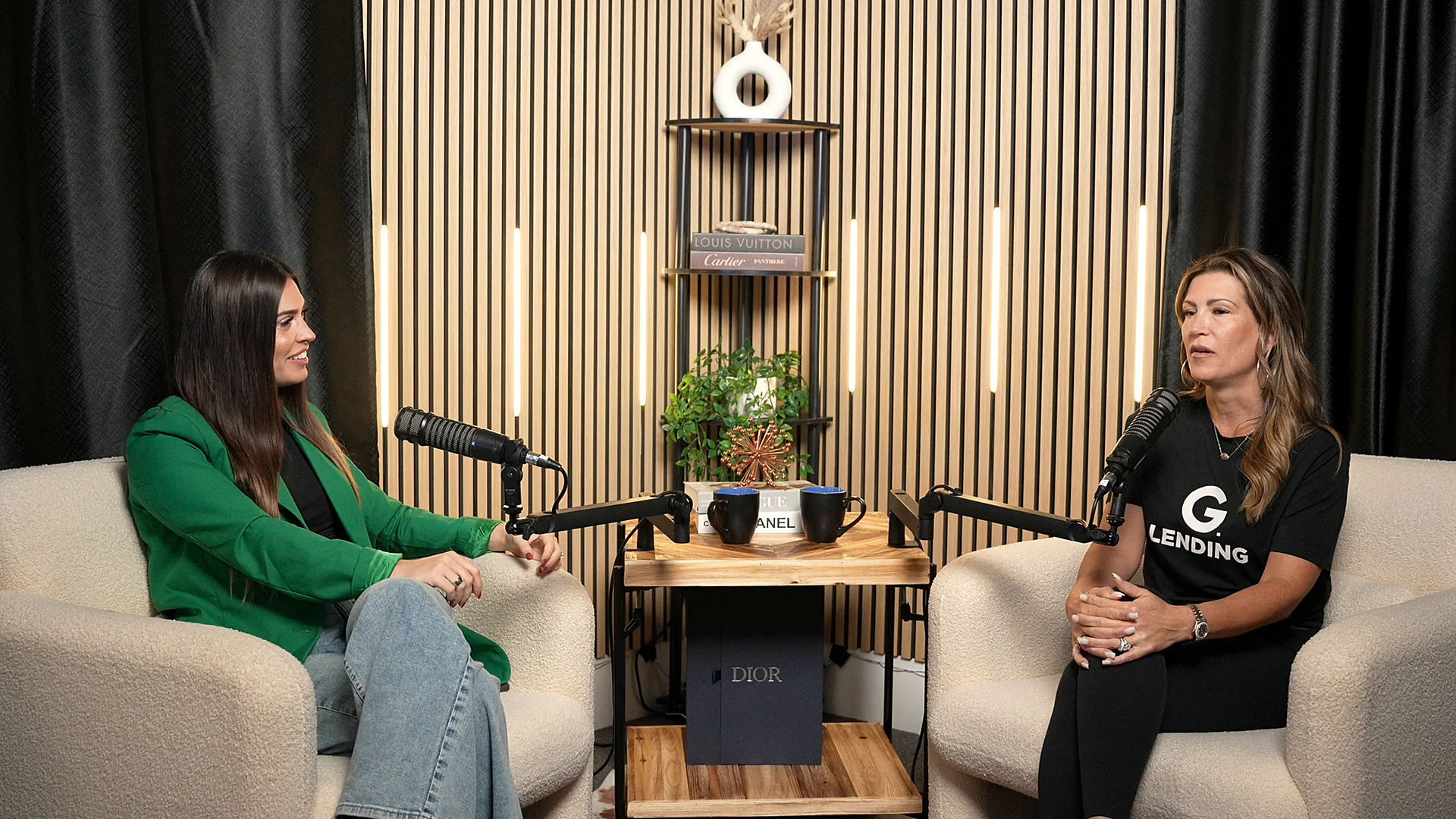 Two G. Lending team members in conversation at the studio